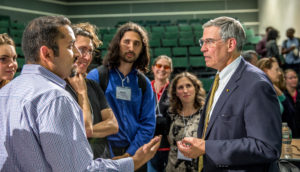 Symposium attendees in discussion with keynote speaker Rush Holt. Picture by Alina Chan.